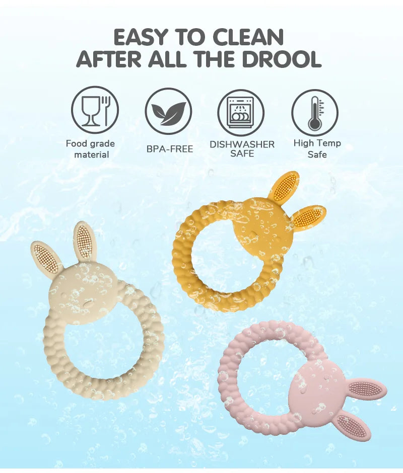 Three Tipi Tipi Tap Rabbit Silicone Baby Teether in gold, beige, and pink on a light blue background with text about their cleaning information