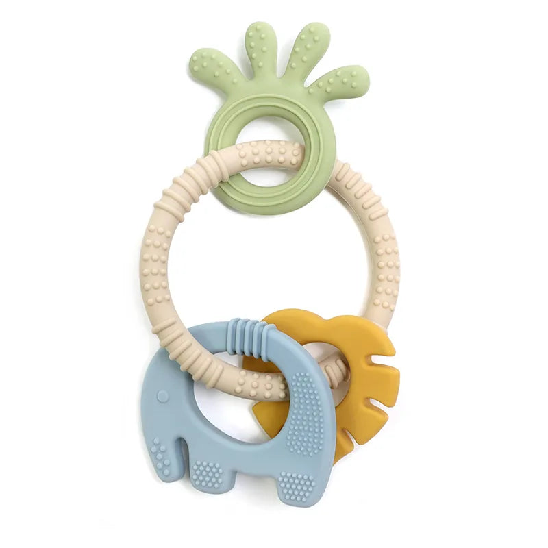 Tipi Tipi Tap 4 in 1 silicone baby teether ring set with green, beige, blue, and yellow colors on a white background