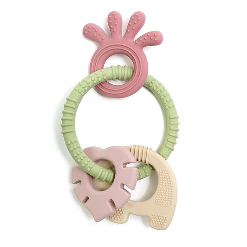 Tipi Tipi Tap 4 in 1 silicone baby teether ring set with pink, green, and beige colors on a white background