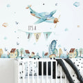 Nursery room with airplane wall decal, 'It's a Boy' banner, and crib.