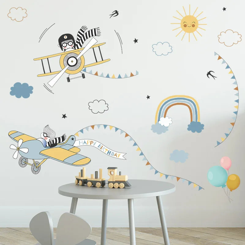 Children's room with wall decals of airplanes, a rainbow, and balloons.