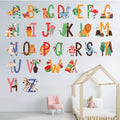 Children's room with colorful Tipi Tipi Tap Animal Alphabet Wall Decal letters, a pink chair, and a wooden house-shaped bed. 