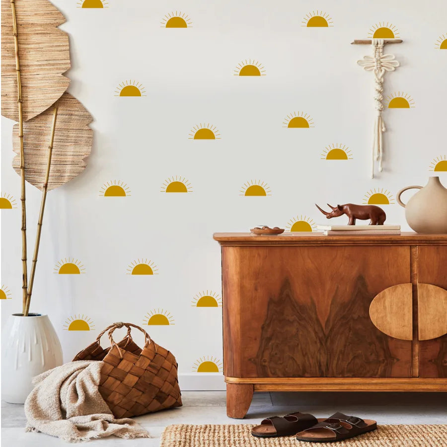 Wooden dresser with decorative items against a wall with Tipi Tipi Tap mini half sun wall stickers.