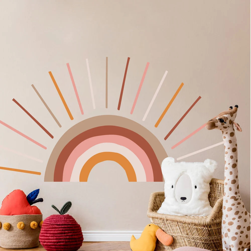 Children's room with a This Tipi Tipi Tap Boho Sunshine Bliss Half Sun wall sticker, toys, and a giraffe plush toy.