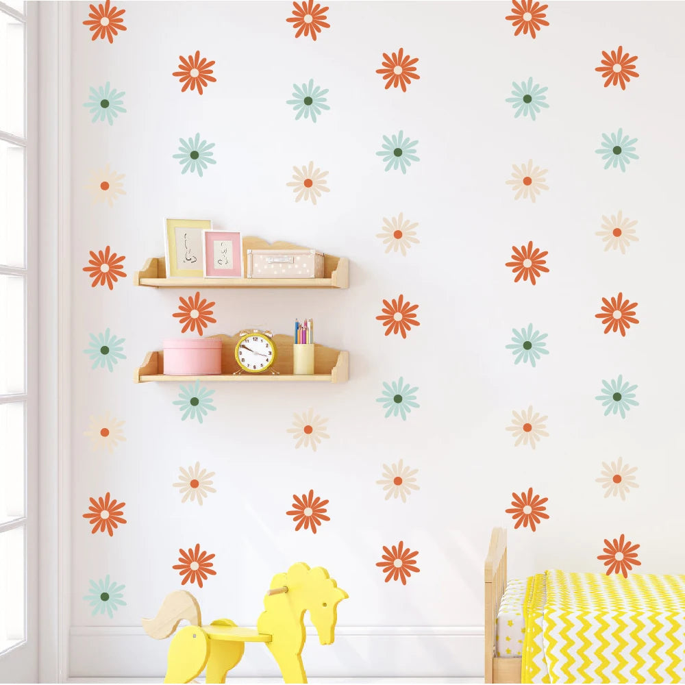 Children's room with Pumkins colorful flower decals on the wall, shelves with toys, and a yellow rocking horse.