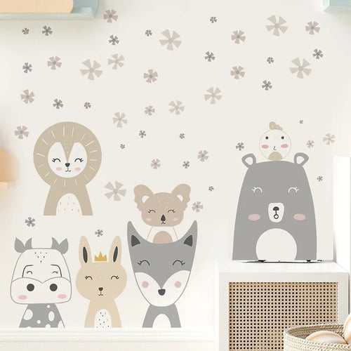 Children's wall stickers of animals on a light-colored wall with decorative elements.