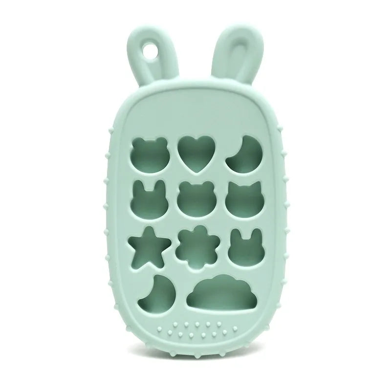 Green Tipi Tipi Tap bunny calculator silicone teether without buttons with hollow animal and star shapes on a white background