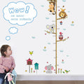 Child looking at a height chart with animal illustrations on a wall.