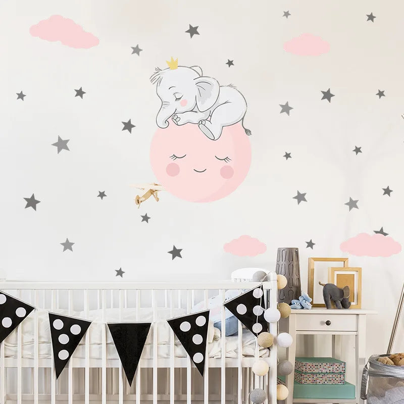 Children's room with crib, decorative wall stickers of an elephant and moon, and a banner.