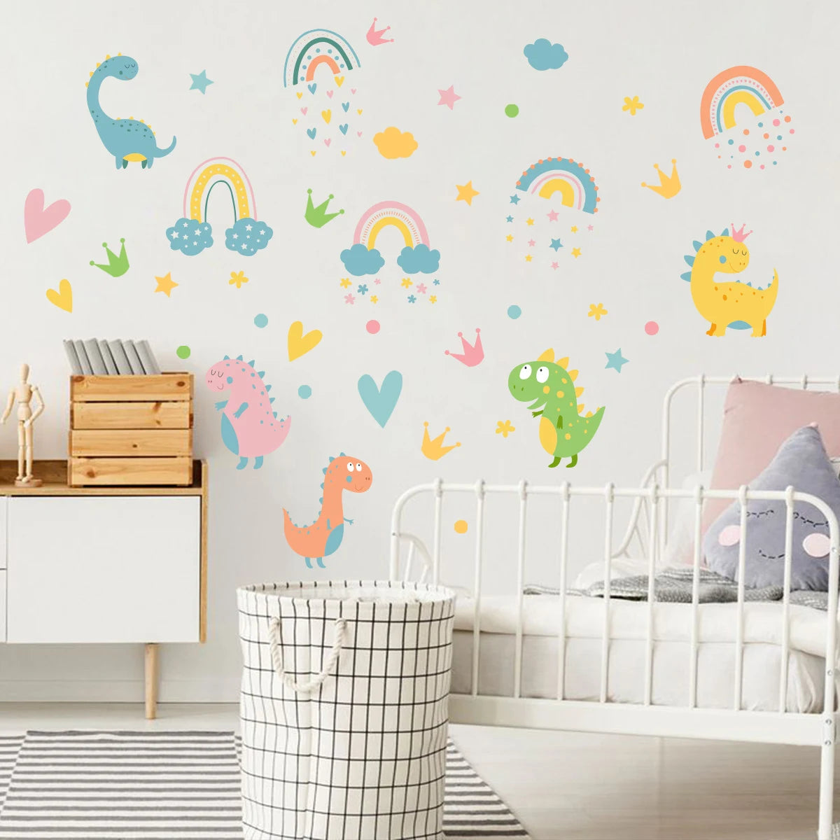 Children's room with colorful Tipi Tipi Tap dinosaur and rainbow wall decals on a white wall and bed and basket.