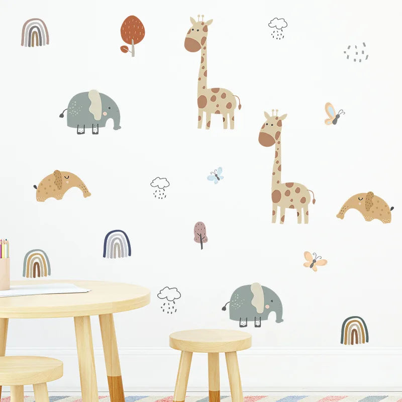 Children's room with animal wall decals on a white wall, including giraffes, elephants, and rainbows.
