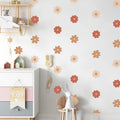 Children's room with floral wall decals, a white cabinet, and decorative items.