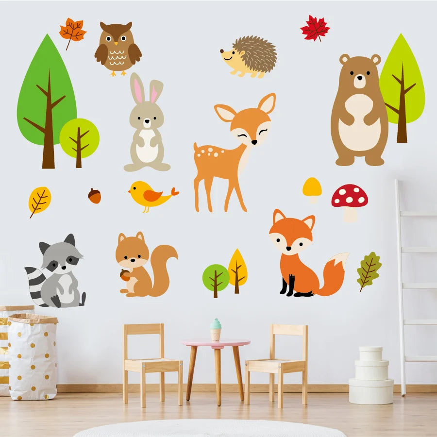 Woodland animal wall stickers on a white wall with furniture below.