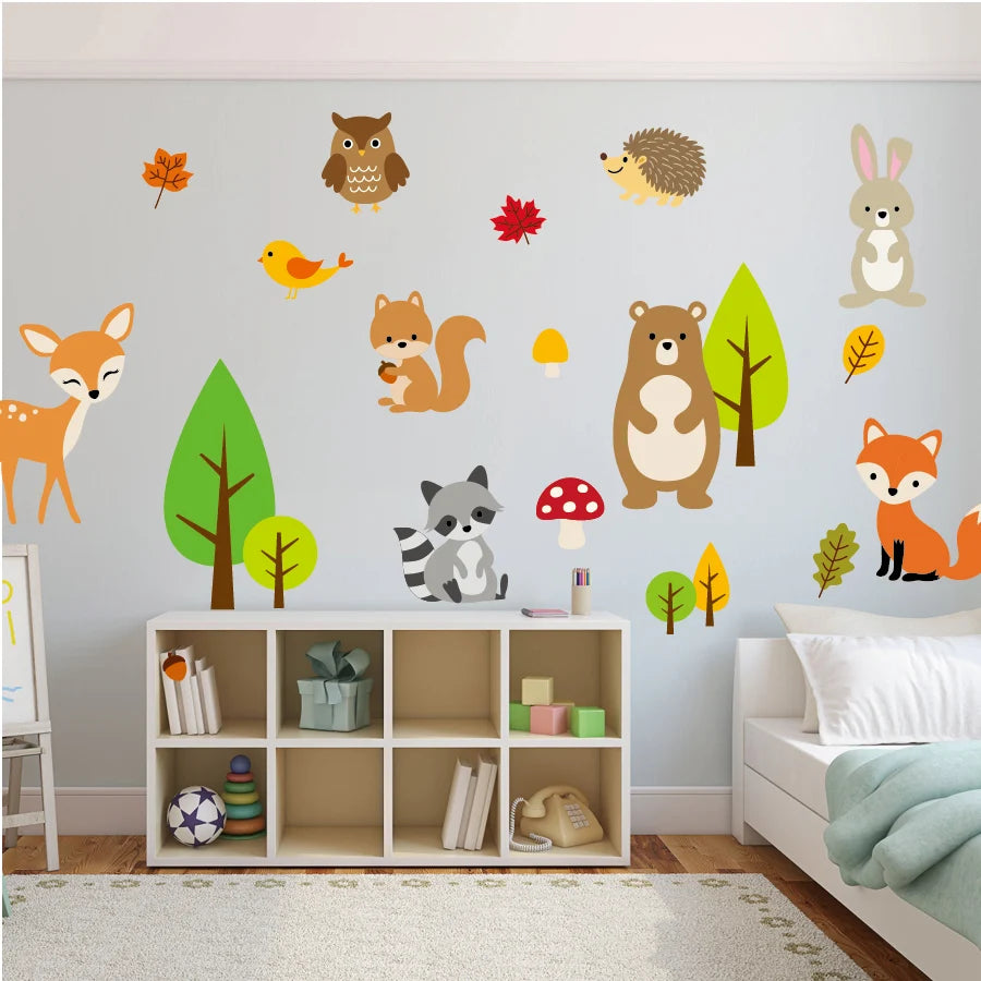 Children's room with forest animal wall decals on a light blue wall.