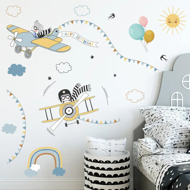 Children's room with airplane wall decals, balloons, and a bed with patterned bedding.