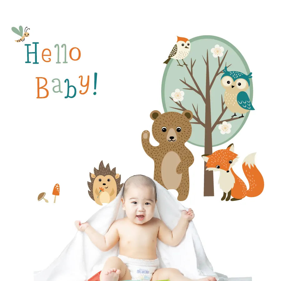 Baby sitting in front of Tipi Tipi Tap "Hello Baby" Jungle Animal Wall Decals.