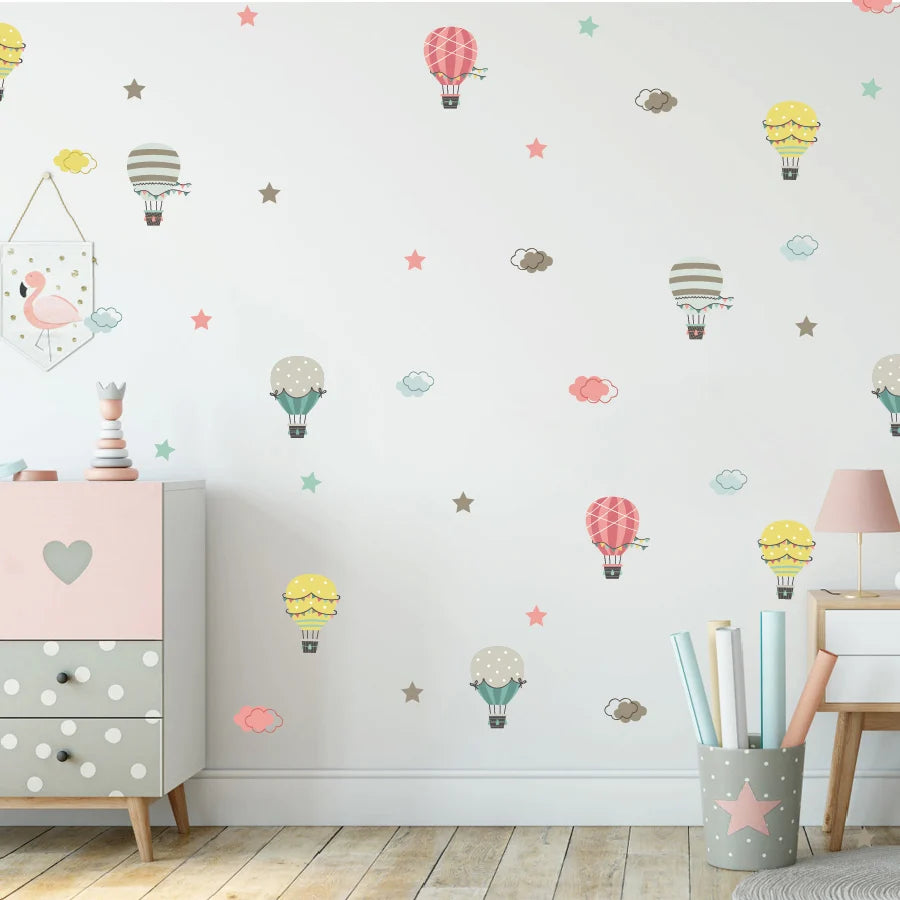 Children's room with Tipi Tipi Tap Hot Air Balloon & Cloud  wall decal comprising hot air balloons and stars on a light gray wall.