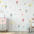 Children's room with Tipi Tipi Tap Hot Air Balloon & Cloud  wall decal comprising hot air balloons and stars on a light gray wall.
