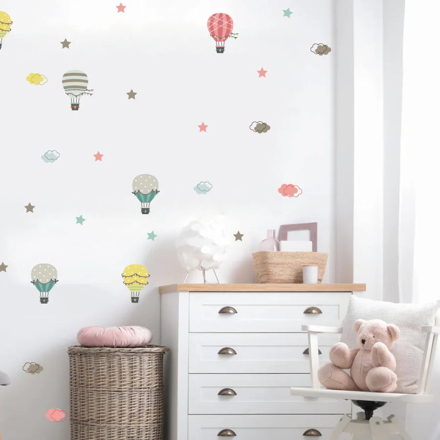 Children's room with white dresser, teddy bear, and Tipi Tipi Tap Hot Air Balloon & Cloud wall decal.