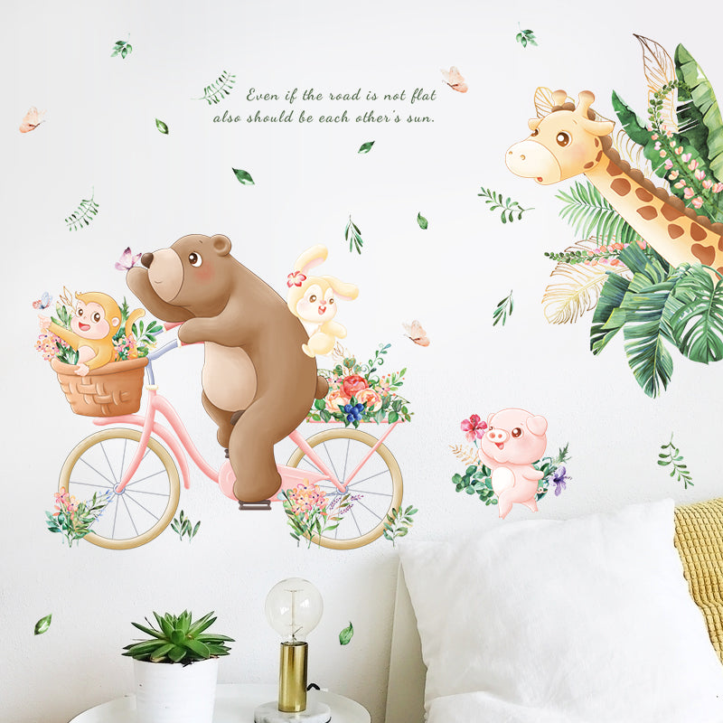 Wall decal with bear on a bicycle, monkey, and giraffe with floral elements.