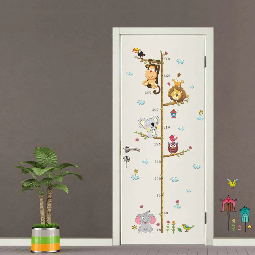 Children's growth chart with animal illustrations on a door next to a plant against a gray wall.