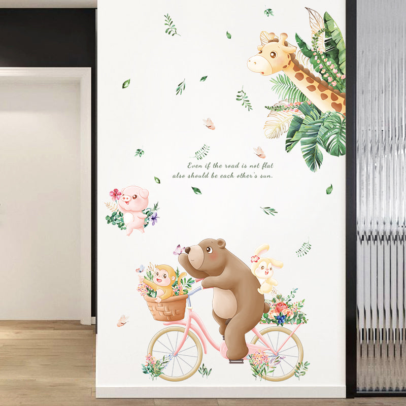 Wall decal with a bear on a bicycle, rabbit in a basket, and giraffe among flowers.
