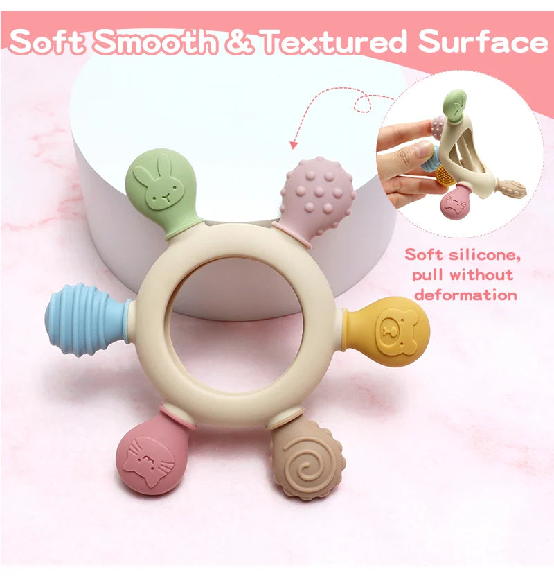 Colorful Rainbow Ring Silicone Baby Teether with various textures on a pink background