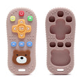 Tipi Tipi Tap Silicone Baby Teether Toy remote control in pink color with bear face design on a white background