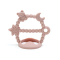 Pink Tipi Tipi Tap silicone wrist teether with star, moon and bear shapes on a white background