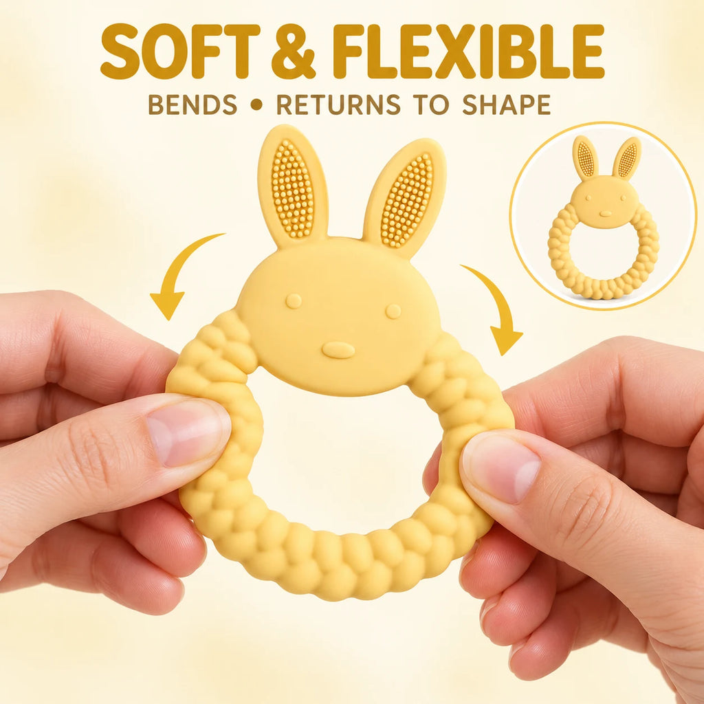 A yellow Tipi Tipi Tap Rabbit Silicone Baby Teether being held by two hands to demonstrate its soft flexibility, with text reading 'SOFT & FLEXIBLE' and 'BENDS • RETURNS TO SHAPE' on a light beige background.