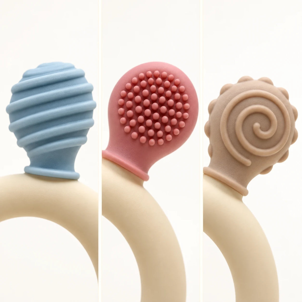 Three Tipi Tipi Tap Rainbow Ring Silicone Baby Teether shown side by side on a white background, each with a different textured handle: a blue ribbed bulb, a pink nubby oval, and a beige spiral design.