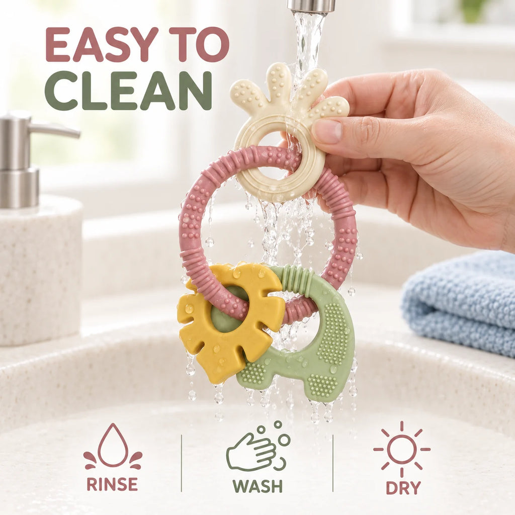 A hand holds Tipi Tipi Tap 4-in-1 Silicone Baby Teether Ring Set with a pink ring, yellow sun-shaped piece, and green elephant-shaped piece under running water in a sink. Text reads 'EASY TO CLEAN' with icons for rinse, wash, and dry.