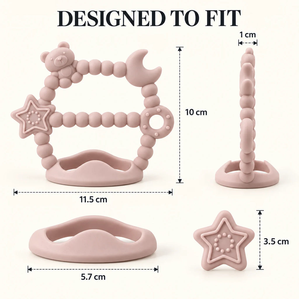 Pink Tipi Tipi Tap Silicone Baby Wrist Teether (Moon & Star) with dimension labels showing the front view, side view, ring, and star piece on a light cream background with 'DESIGNED TO FIT' text at the top.