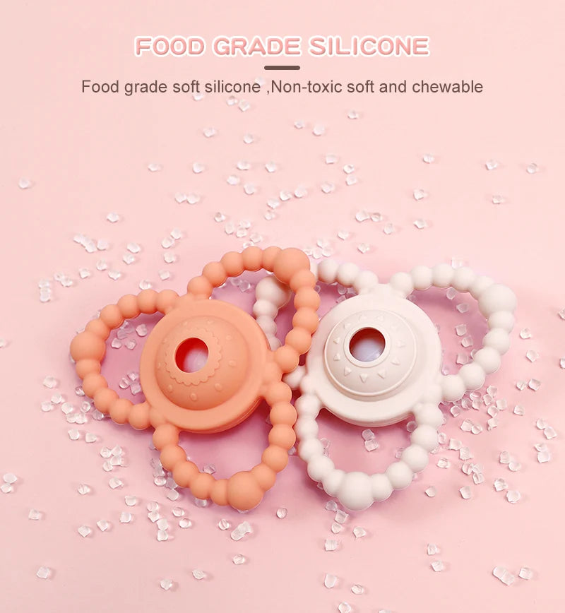 Two silicone Tipi Tipi Tap Triangular Rattle Teether on a pink background with text about food-grade silicone.