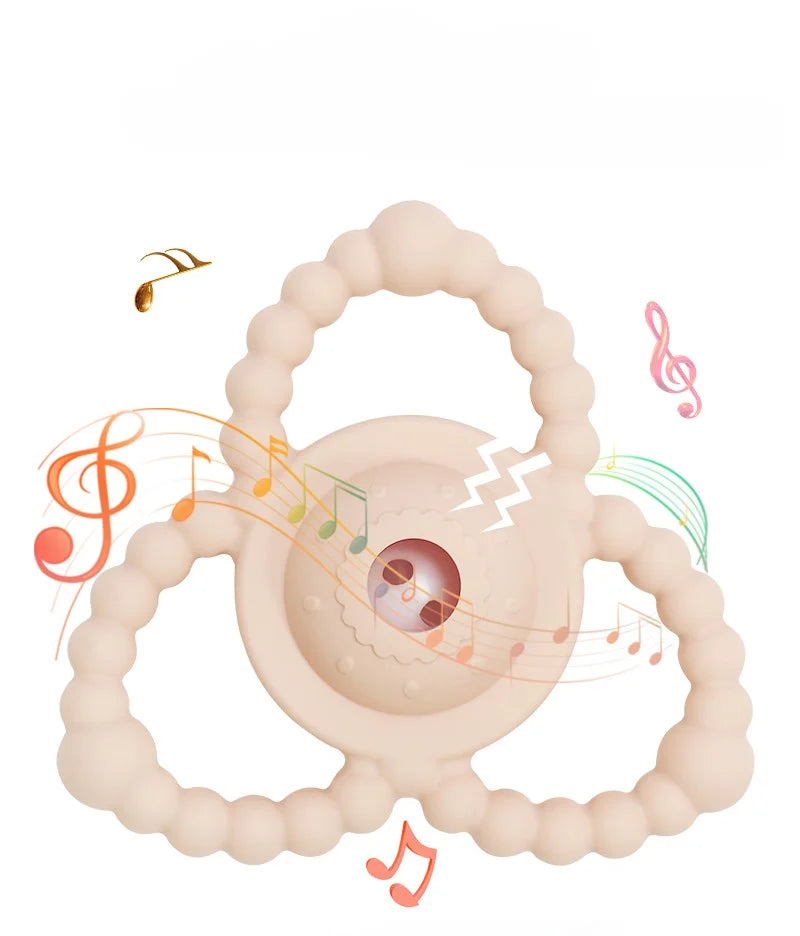 Tipi Tipi Tap Triangular Rattle Teether with illustration of musical notes around it on a white background.