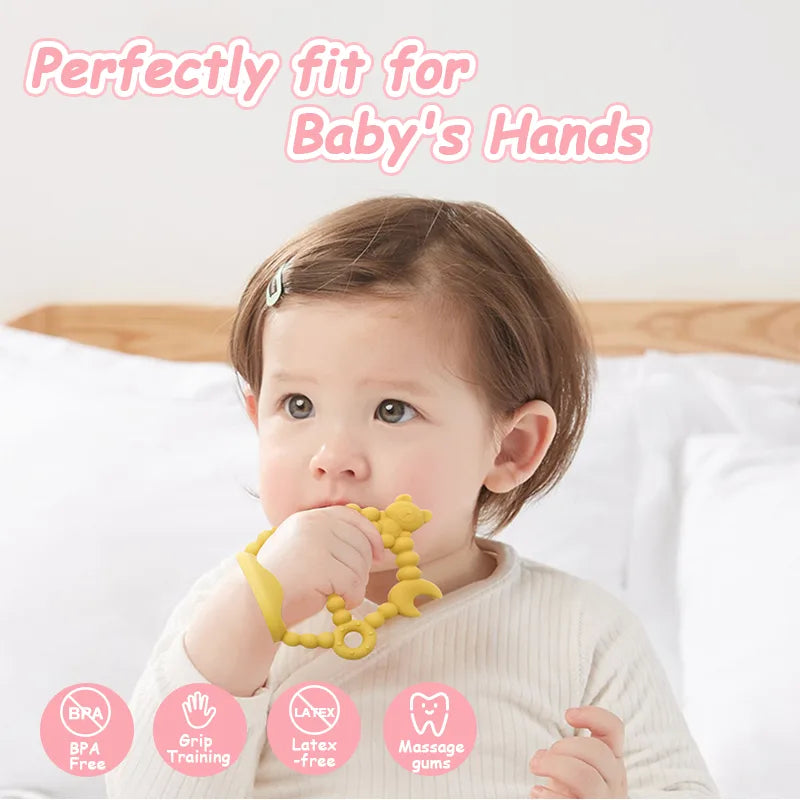 Baby holding a yellow Tipi Tipi Tap Wrist teether toy with text 'Perfectly fit for Baby's Hands' and safety features listed.