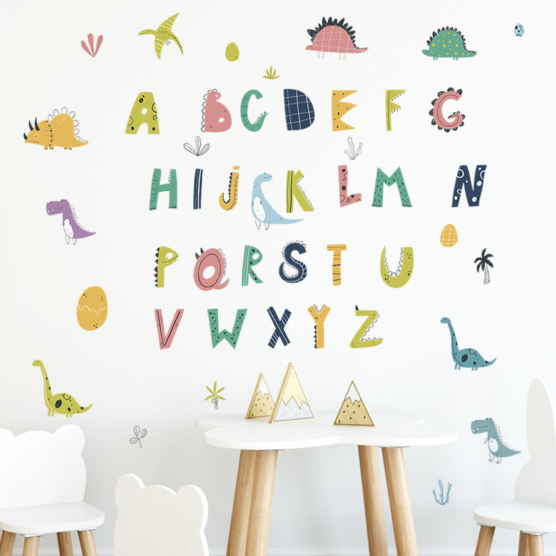 Colorful alphabet and number wall decal with dinosaur illustrations on a white wall.