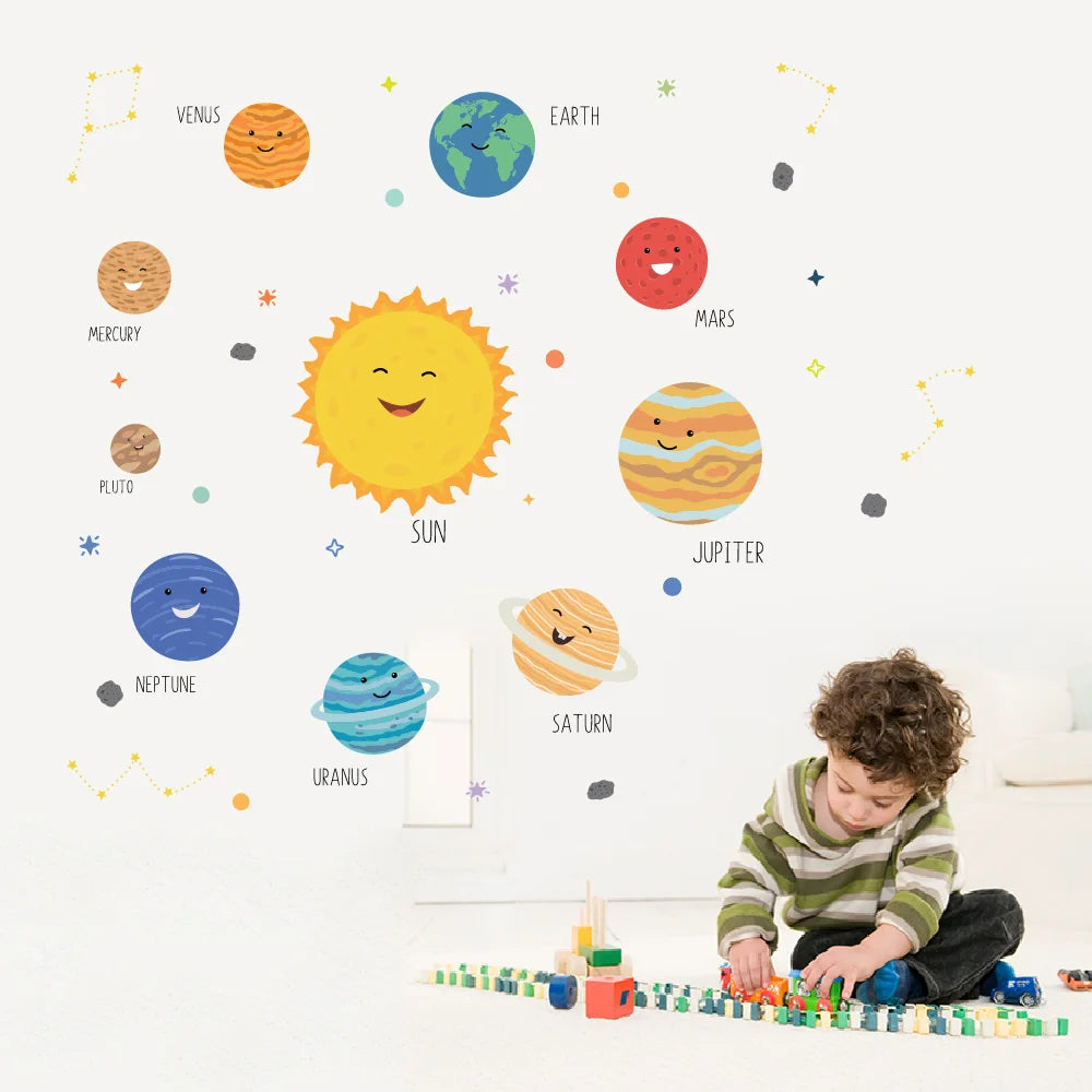 Child playing with toys in front of a wall with Pumkins solar system-themed wall stickers.