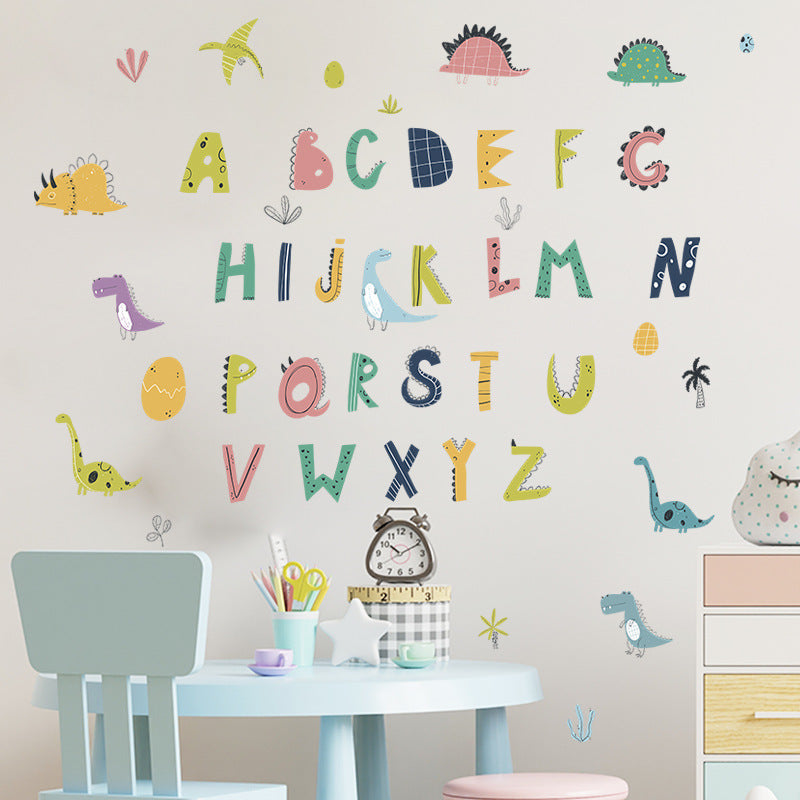 Children's room with Pumkins alphabet and dinosaur wall decals on a light pink wall.